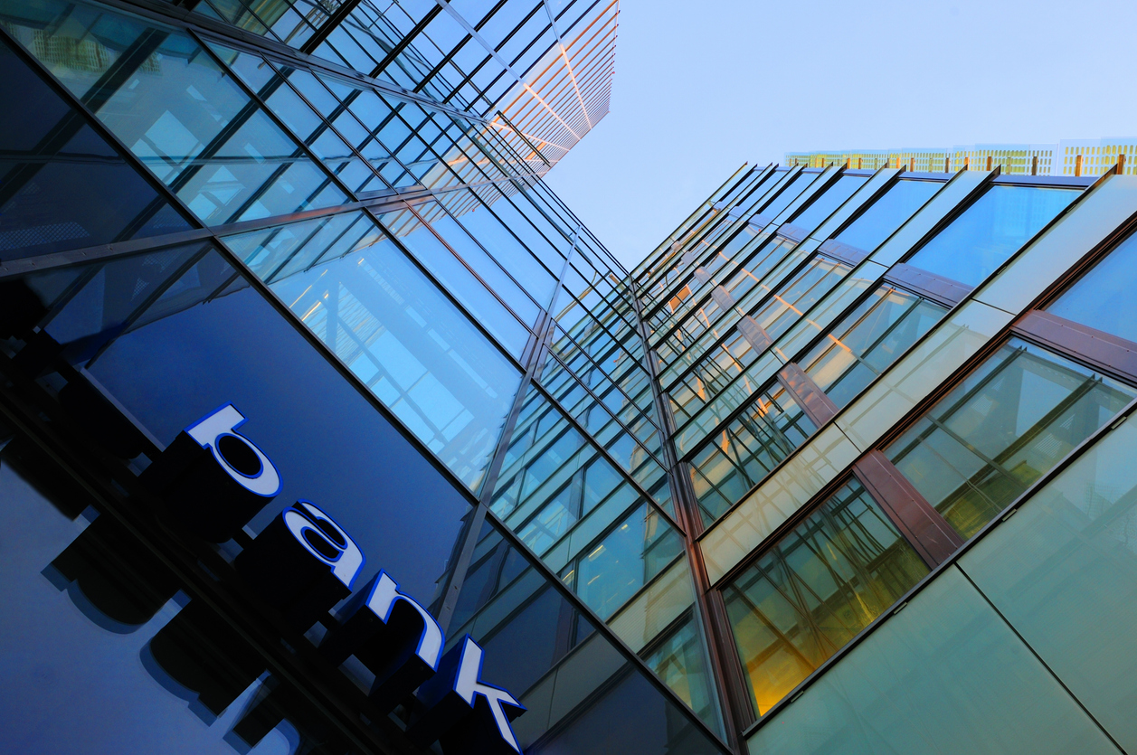 Glass bank headquarters tower seen from street level
